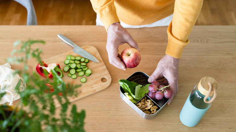 man preparing snack with grapes