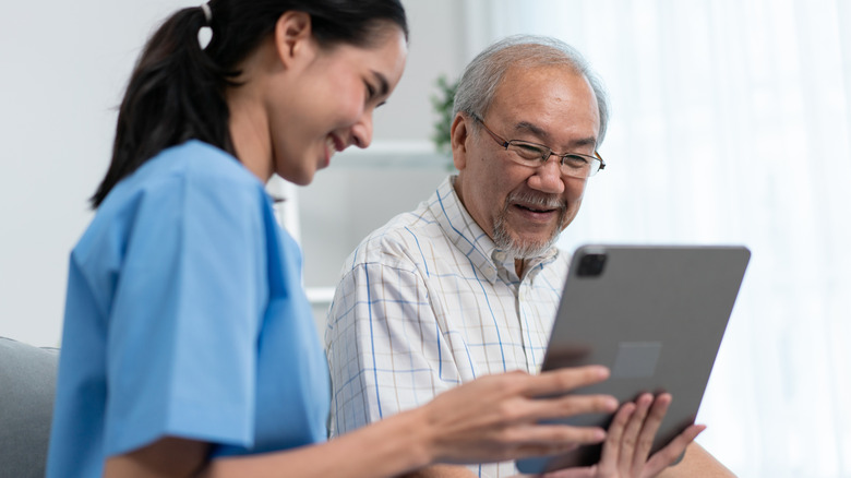 A female medical technician showing a man positive results