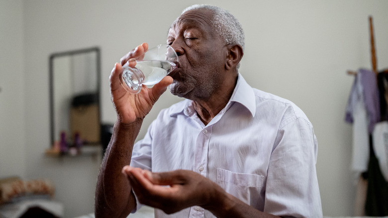 Older man drinking water