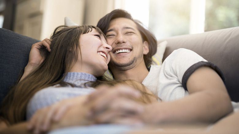 Smiling couple on couch