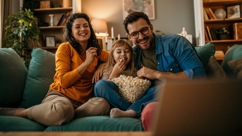 family on couch eating popcorn