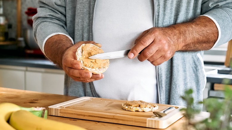 man spreading peanut butter