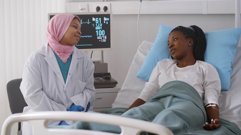 Patient talking to a doctor in a hospital room