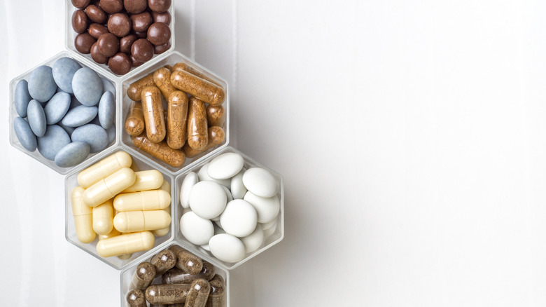 capsules and pills in hexagon shaped dishes