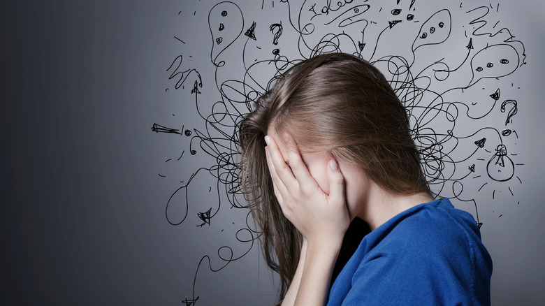 anxious woman with her head in her hands