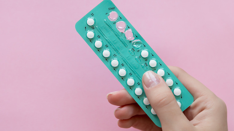 birth control pills on a pink background