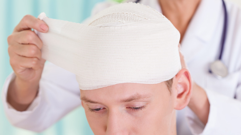 young man bandaged for head injury
