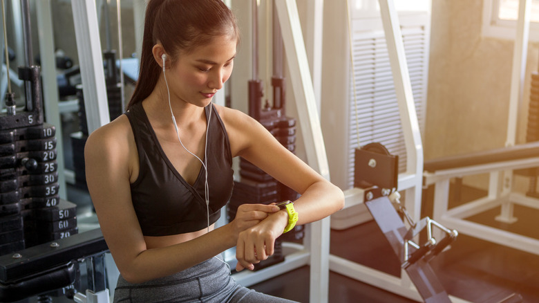 Woman looking at fitness watch