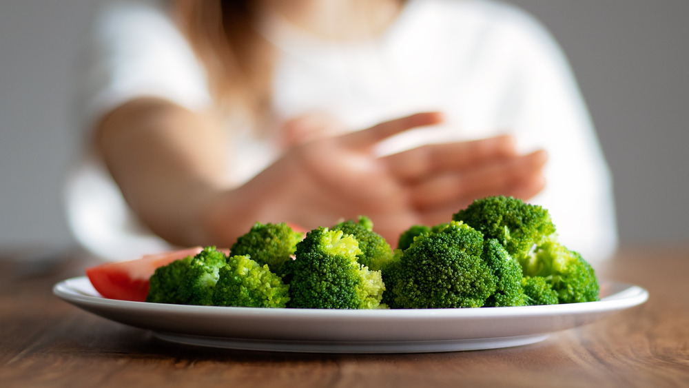pushing away plate of broccoli