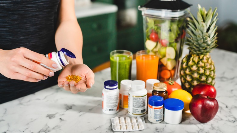 Collection of supplement bottles and fruits