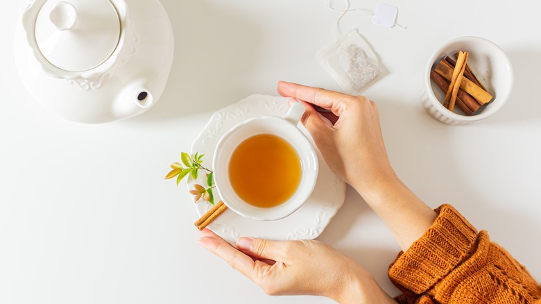 Woman holding cup of tea