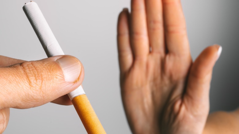 person's hand refusing cigarette 