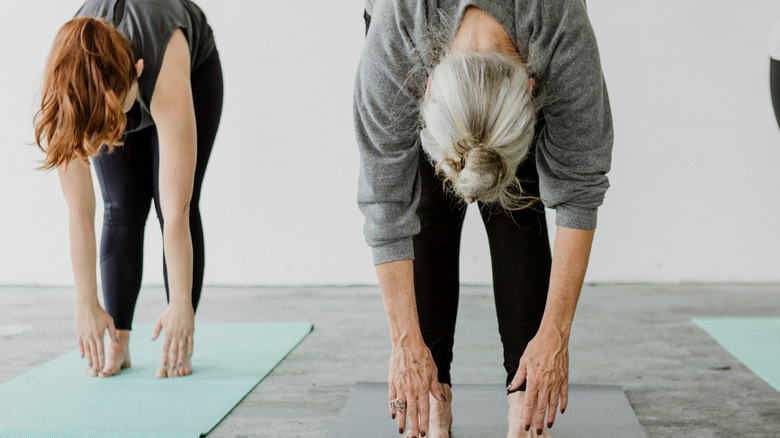 group of people doing forward folds