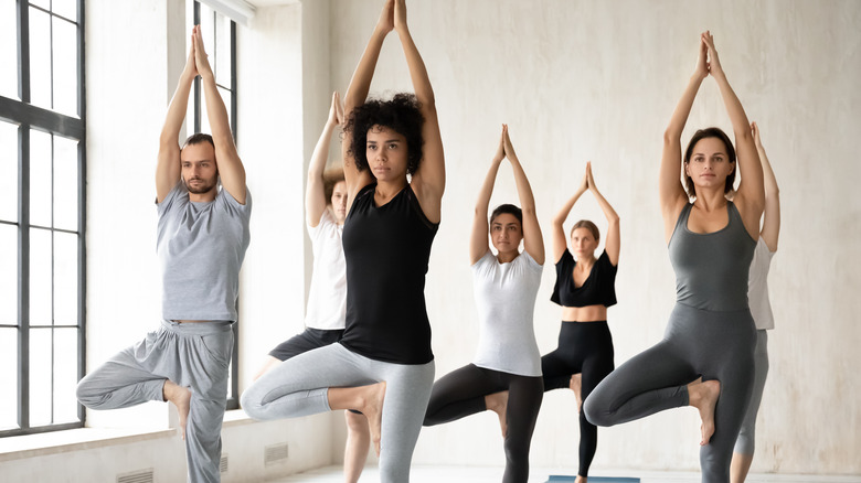 people in a full yoga class