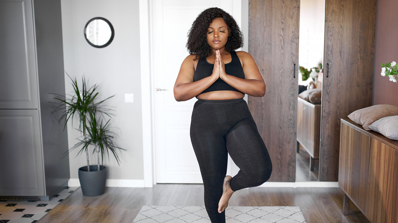 woman standing doing yoga 