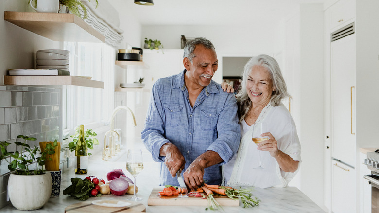 Elderly couple preparing vegetables