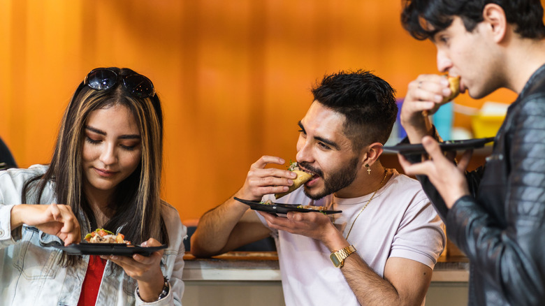 Friends eating tacos together