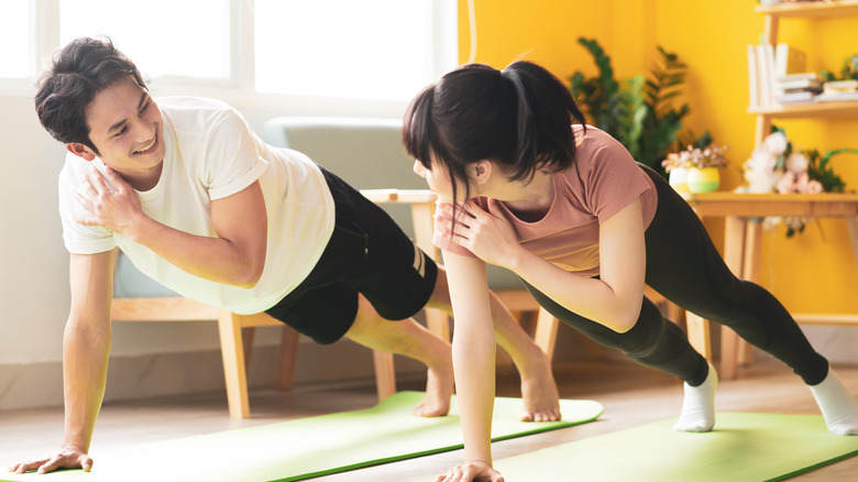 couple doing exercise at home