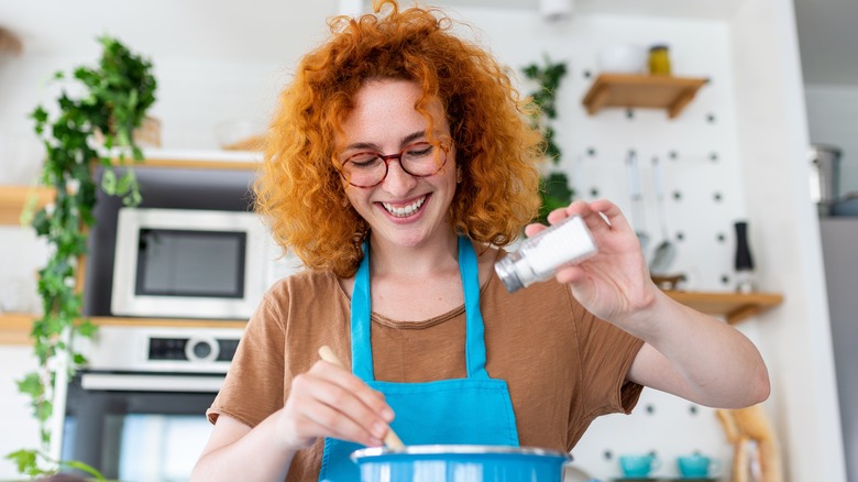 Woman cooking pasta in pot