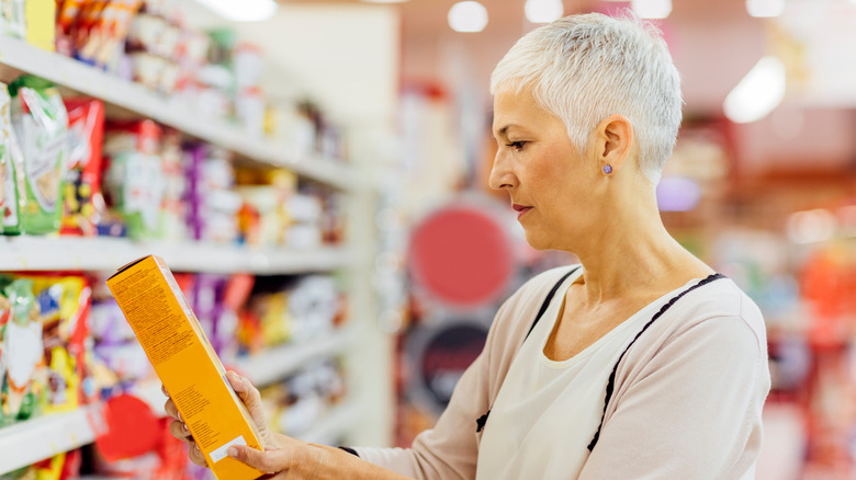 woman reading gluten-free snack's label