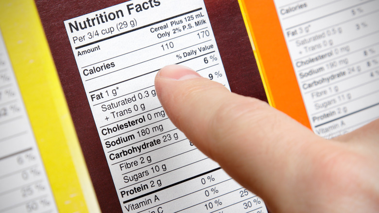 person looking at nutrition label