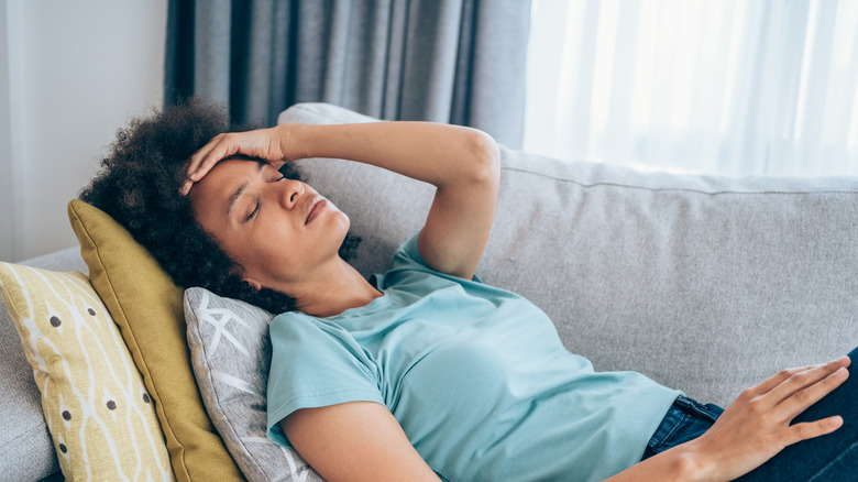 tired woman resting on couch