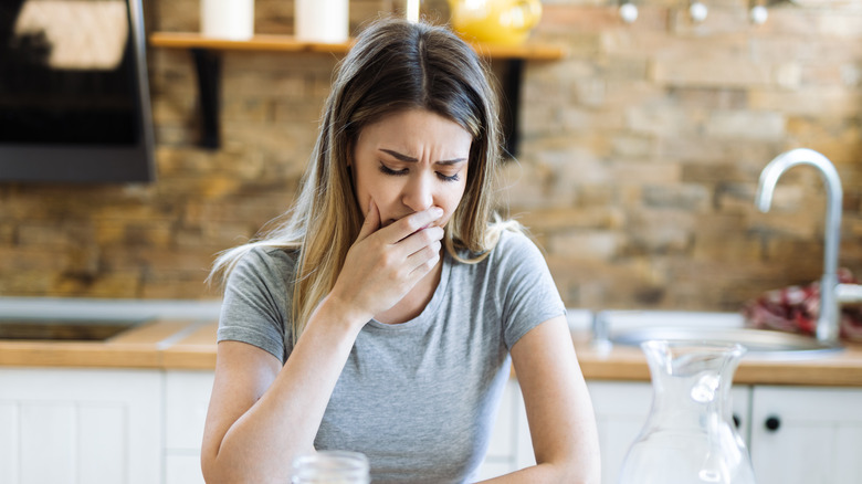 Woman feeling unwell after eating