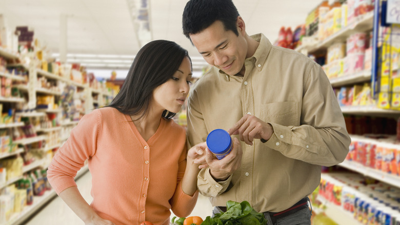 A couple shopping for peanut butter