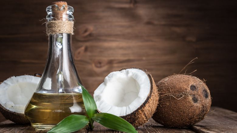 Coconut and oil on a wooden background