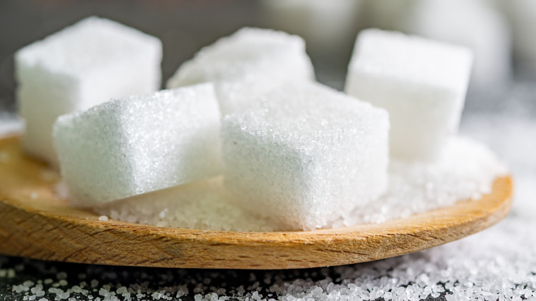 Sugar cubes on a round wooden surface