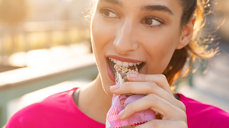 Woman eating protein bar