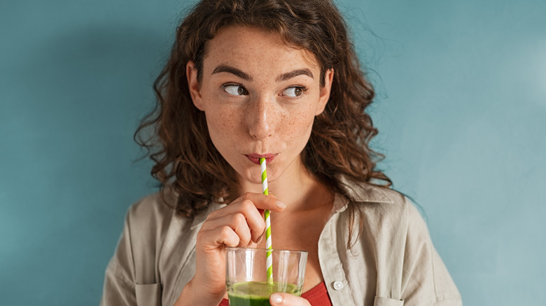 woman drinking smoothie