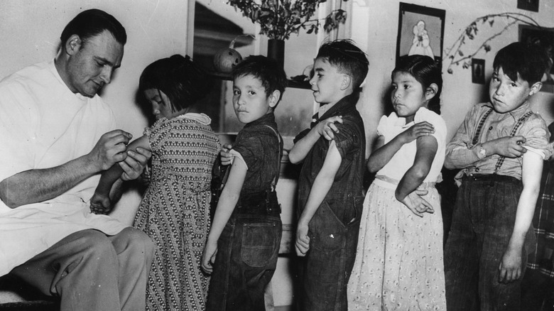 Kids lining up for vaccinations - historical