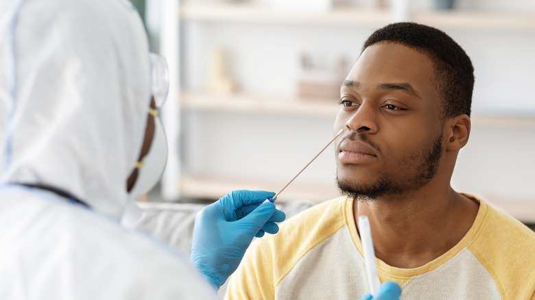 Young man receiving a COVID-19 PCR swab test