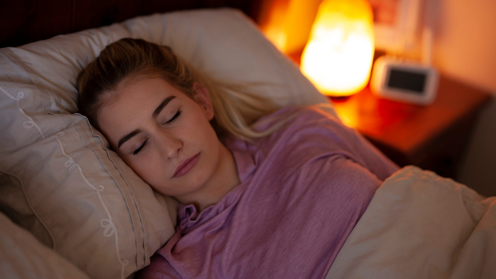 woman sleeping with salt lamp