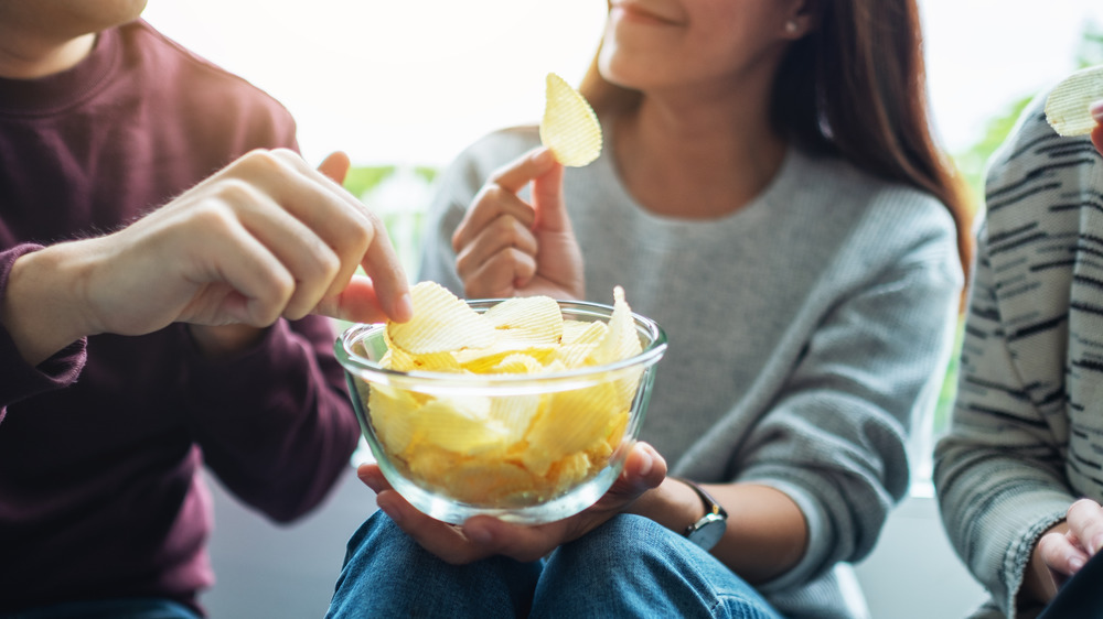 group eating potato chips together