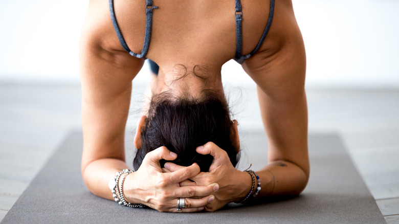 back of woman's head in headstand