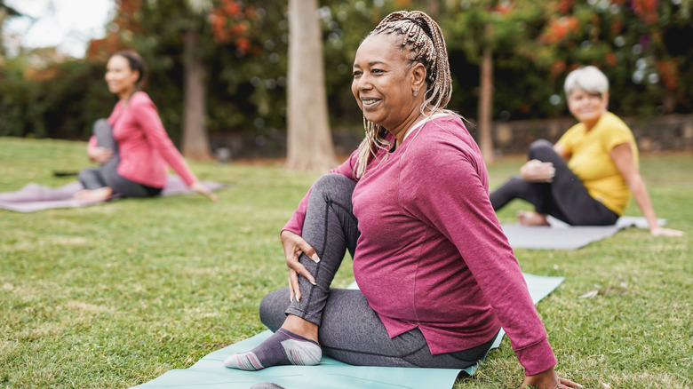 older woman in seated yoga twist