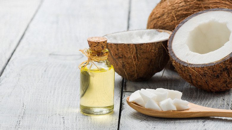 coconut oil and coconut with wooden spoon