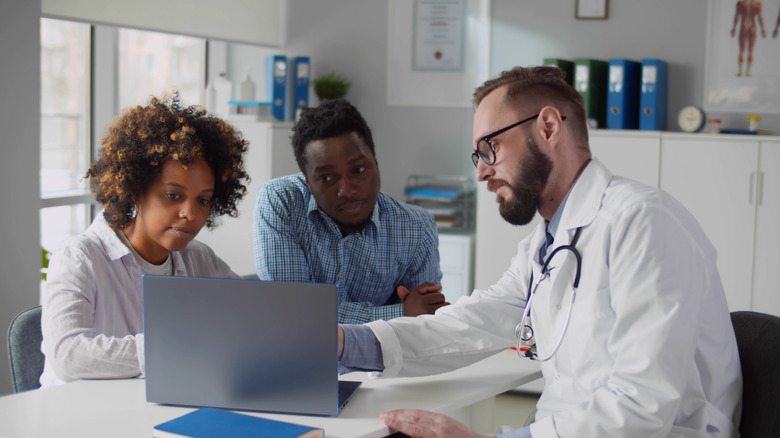 Doctor talking to a couple