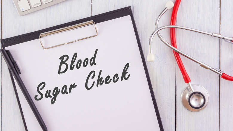 clip board that says "blood sugar check"