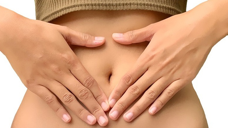 Woman holding stomach