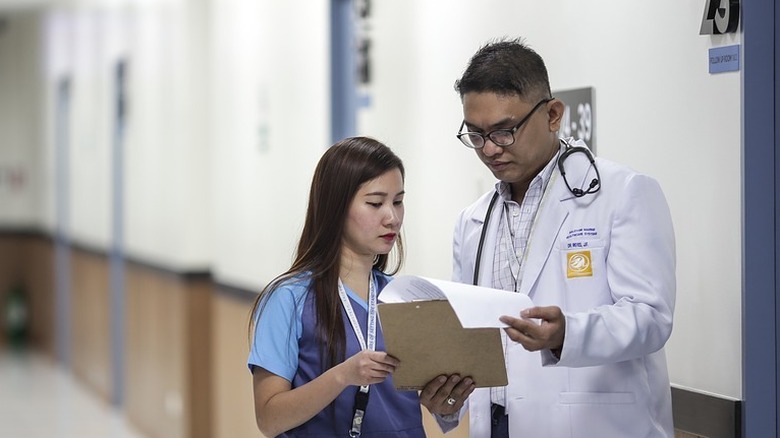 Doctor and assistant in hallway