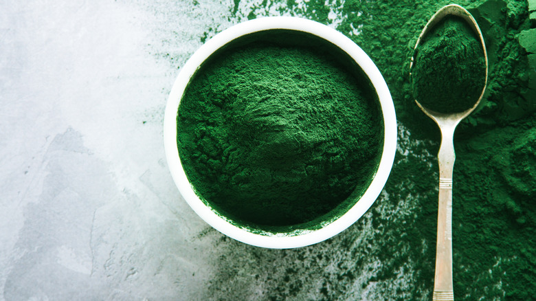 greens powder in bowl alongside spoon