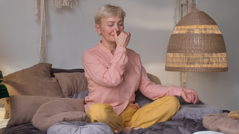 senior woman practicing nadi shodhana