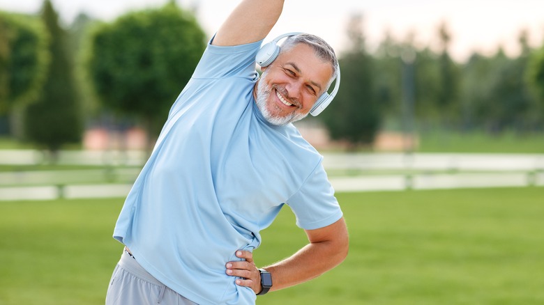 Man stretching in park