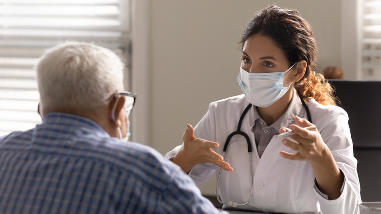 Elderly man speaking with doctor