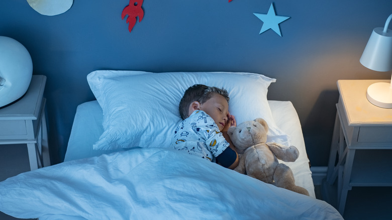 Young boy sleeping in room