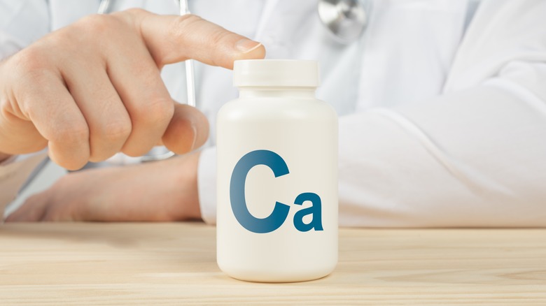 Doctor with finger on calcium pills
