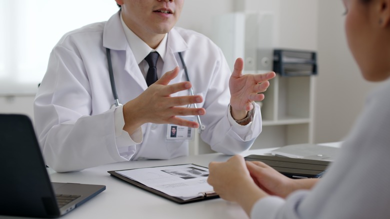 dermatologist talking with patient